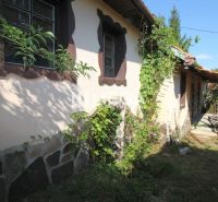 A family house on Kudlovská Street in Humenné with stone cladding and climbing plants.
