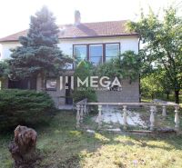 A family house on Kudlovská Street in Humenné, surrounded by greenery, with a garden terrace.