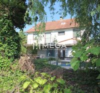 A family house on Kudlovska Street in Humenné with lush greenery and a swimming pool.