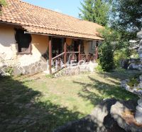 A family house on Kudlovská Street in Humenné with a stone facade and a garden fountain.