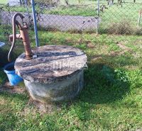 A hand pump on a well on a residential plot by the road in Humenné.