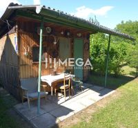 A small wooden garden cottage with a shelter in the garden of a family house in Hažín nad Cirochou.