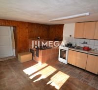 A kitchen in a family house with tiles and cabinets, flooring with a wood decor.