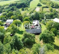 An aerial view of family houses surrounded by greenery in Vyšné Ladičkovce.