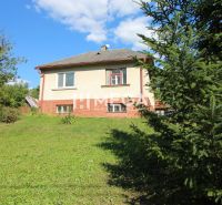 A family house in Vyšné Ladičkovce surrounded by greenery on a quiet street.