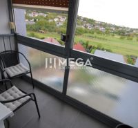 A glazed balcony with a view of greenery and the village, from a 3-room apartment.