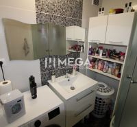 Bathroom in a 3-room apartment with a sink, washing machine, and storage space.
