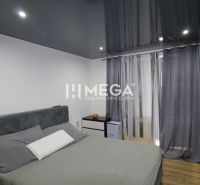 Bedroom with a bed, modern lighting, and a wooden decor floor.