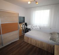 A bedroom in a 3-room apartment with a sliding wardrobe and a floor with a wooden decor.