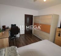 Bedroom with a desk, wardrobe, and wooden decor flooring in a 3-room apartment.