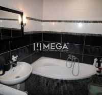 A bathroom in a 3-room apartment with a shower, sink, and modern tiles.