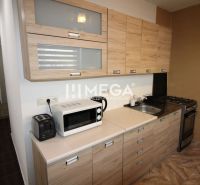 A kitchen in a 3-room apartment with wooden decor and appliances.