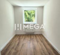 A room in a 4-room apartment with a wooden decor floor and a view from the window.