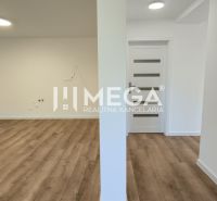 A spacious area with light walls and a wooden decor floor in a 4-room apartment.
