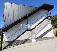 Exterior of a 4-room apartment in Jasenov with a modern facade and an outdoor staircase.