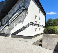 The exterior of the building in Jasenov with side stairs and an access walkway, suitable for a 4-room apartment.
