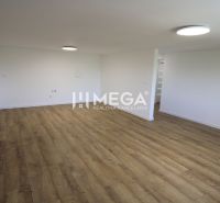 A spacious room with light-colored walls and a wooden decor floor in a 4-room apartment.