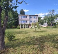 A family house in the Poľana Housing Estate in Humenné surrounded by a garden and trees.