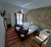 A room in guesthouses and hotels with brick cladding and a wooden decor floor.