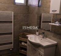 Bathroom with a sink, cabinet, ladder radiator, and floor with wooden decor.