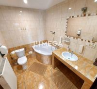 Bathroom in hotels and guesthouses with a bathtub, toilet, and large mirror.