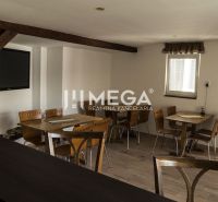 Interior with wooden beams, tables, and chairs in the guest areas of hotels and guesthouses.