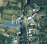 Aerial view of residential plots in Vyšné Ladičkovce surrounded by fields and forest.