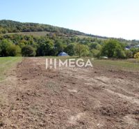 A residential plot on the outskirts of Vyšné Ladičkovce, surrounded by greenery and hills.