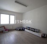 An empty office with a window and a wooden floor, full of binders.