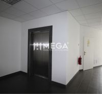 Offices with an elevator, light flooring, and a fire extinguisher in the hallway.