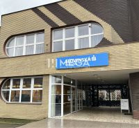 The exterior of the offices on Main Street in Stropkov with dominant rounded windows.