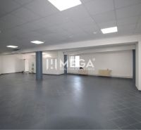 The interior of commercial spaces with dark gray flooring and white walls.