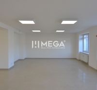 Interior of commercial spaces with ceramic flooring and large windows for natural light.