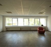Offices with wood-patterned flooring and red chairs.