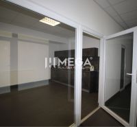 Glazed entrance doors in an office with tiles and fire extinguishers.