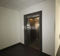 Offices with dark flooring and an elevator.