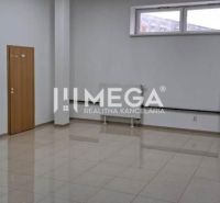 Offices with white walls and a window, floor with wood decor, desk in the corner.