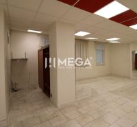 Spacious commercial spaces with tiles and wall shelves, neutral colored walls.