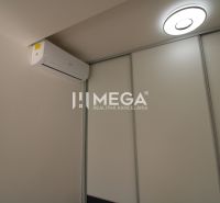Air conditioning and lighting in a 2-room apartment with white sliding doors.