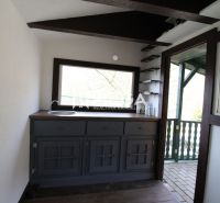 Interior with a kitchen unit, window, and floor with wood decor in Gardens.