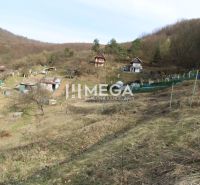 Gardens on the slope in Humenné at ZO Poniklec with several wooden cabins.