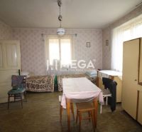 Interior of a family house with retro furniture, two beds, and a wooden decor floor.