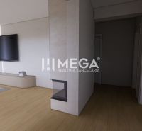 Living room with a TV, table, and wooden decor flooring in a family house.