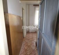 A narrow hallway in a 2-room apartment with linoleum and built-in wardrobes.