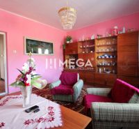 Living room in a family house with pink walls, furniture, and decorations.