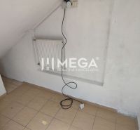 A small room with white walls, a chair, and a radiator, commercial premises.
