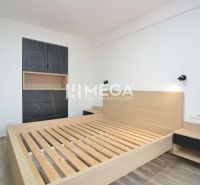 A bedroom with wooden decor, a bed, and a built-in wardrobe in a 3-room apartment.