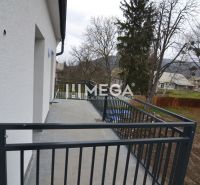 A balcony in a 3-room apartment on Pod hradom Street in Strážske with a view of the garden.