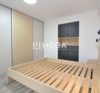 Bedroom in a 3-room apartment with a bed and storage space in a dark decor.