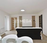 Living room in a three-room apartment with a wooden decor floor and elegant furnishings.